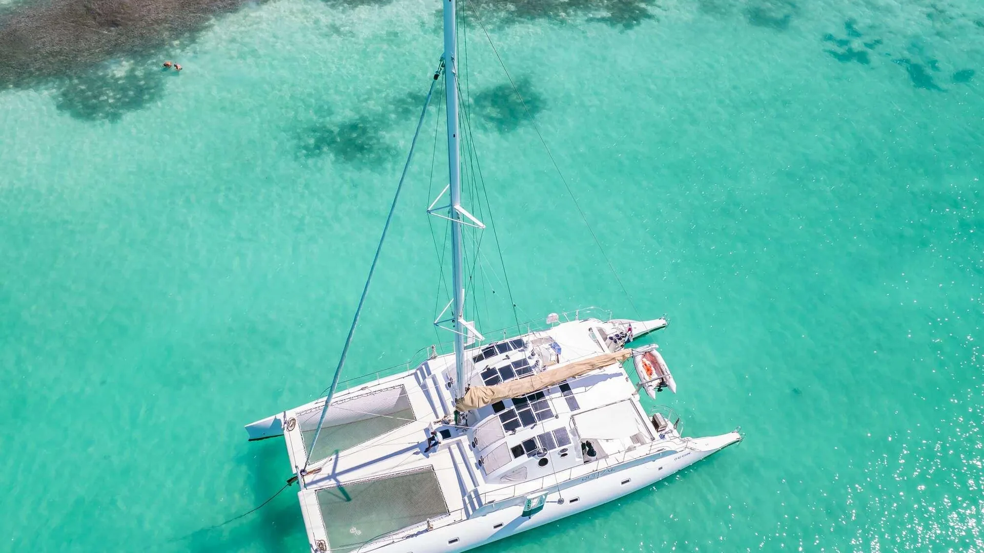 Aerial view of a catamaran over turquoise shallows near Saona, from the small-group luxury catamaran listing
